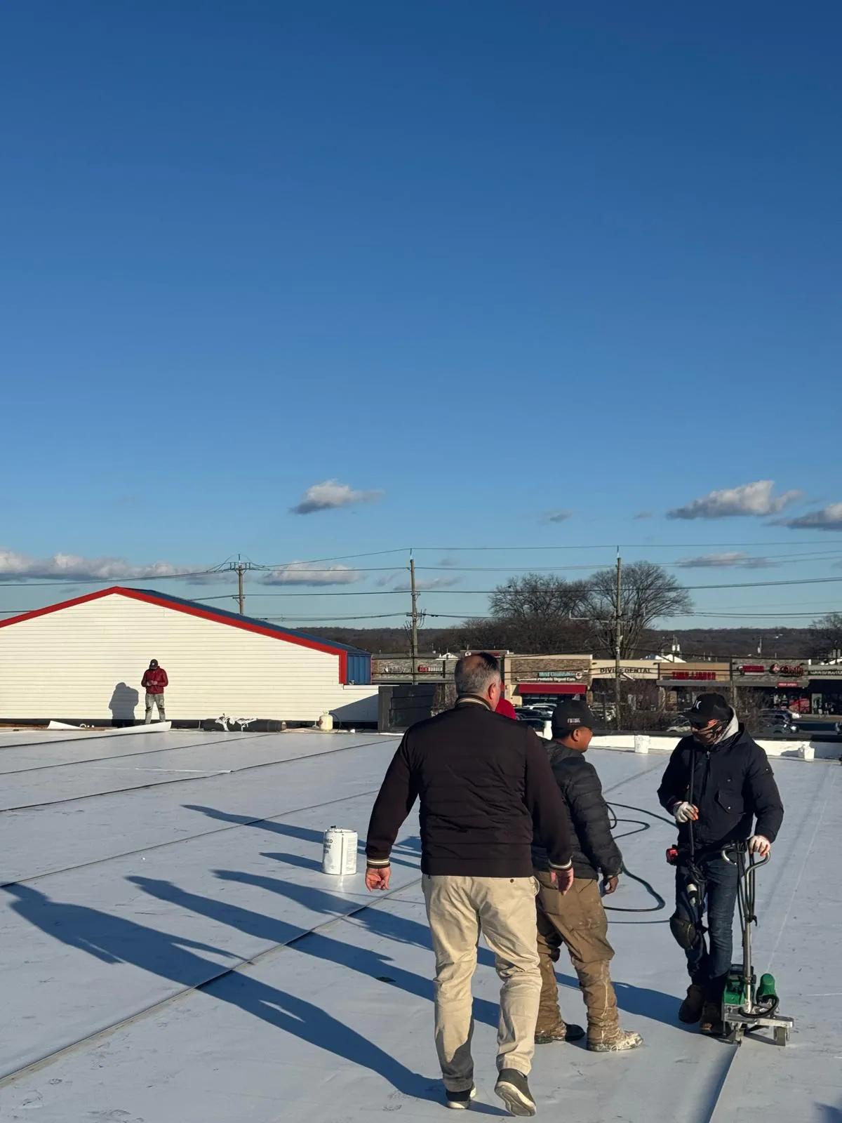 Genc Construction team consulting on roofing project